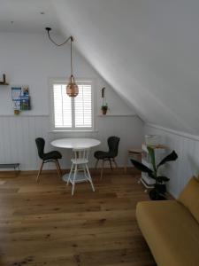 a living room with a white table and chairs at Ferienwohnung Kleiner Onkel in Uhldingen-Mühlhofen