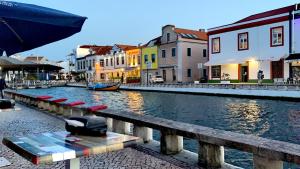 a view of a canal in a city with buildings at Feelings Aveiro Apartment in Aveiro