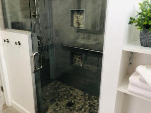 a shower with a glass door in a bathroom at The Landing at Morro Bay in Morro Bay
