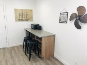 a kitchen with a counter and stools in a room at The Landing at Morro Bay in Morro Bay