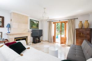 uma sala de estar com um sofá branco e uma lareira em Anima em Can Picafort