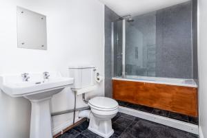 a bathroom with a toilet and a sink and a shower at The Witching Post Inn in Whitby