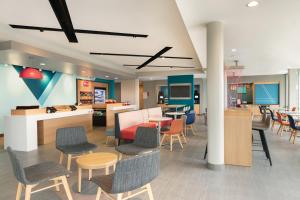 a lobby with chairs and tables and a cafeteria at Avid hotels - Staunton, an IHG Hotel in Staunton