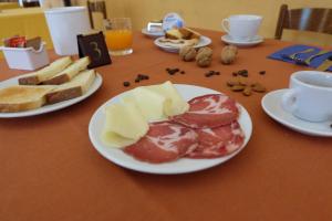 a table topped with plates of food and bread at Hostel il Tetto in Melfi
