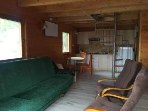 a living room with a green couch and chairs at Filkówka- Słoneczne Wzgórze in Wadowice