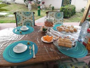 a wooden table with blue plates and food on it at Villa Curti in Rome