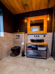 a bathroom with a sink and a mirror at Apartamenty Kowary in Kowary