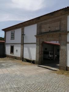 a large white building with a large garage at Apartamento A Fabrica in Santiago de Compostela