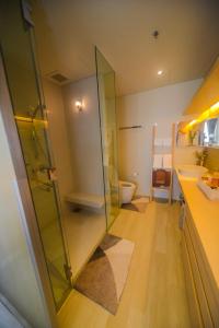 a bathroom with a glass shower and a toilet at Veranda Residence Pattaya Nice Monthly rate available now in Na Jomtien
