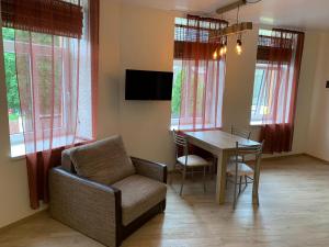 a living room with a table and a chair at Villa Ventus in Liepāja