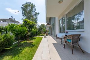 a patio with a table and chairs on the side of a house at EV Apartments in Belek