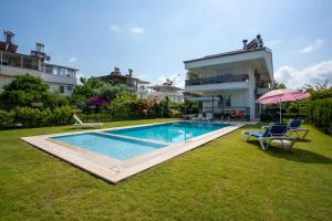 a swimming pool in the yard of a house at EV Apartments in Belek