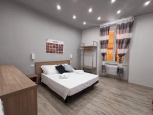 a bedroom with a white bed and a window at A&B Affittacamere a Boccadasse in Genoa