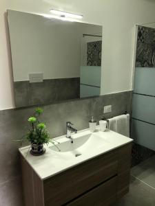 a bathroom with a sink and a large mirror at Mare e Relax in Castellammare del Golfo