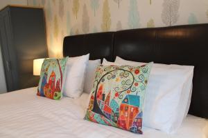 two pillows sitting on a bed next to sidx sidx sidx sidx at BONNIE'S APARTMENT, adults only in Bowness-on-Windermere