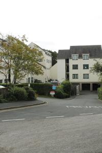 a parking lot in front of two white buildings at BONNIE'S APARTMENT, adults only in Bowness-on-Windermere