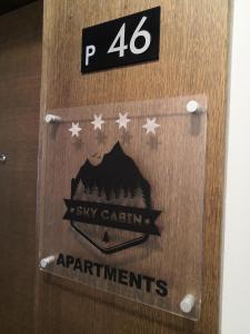 a wooden door with a sign that says six cabin apartments at Sky Cabin Apartments in Kopaonik