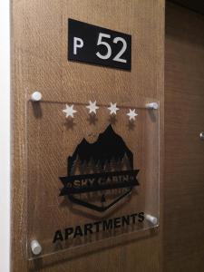 a bathroom door with a sign that reads stay cabin apartments at Sky Cabin Apartments in Kopaonik