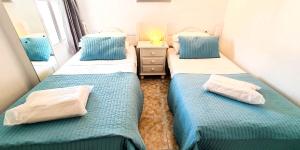 two beds in a room with blue and white at Skol 708 Fantastic 2 Bedroom Apartment For Holiday Rentals in Marbella +28 photos