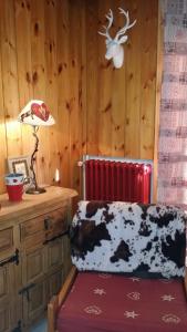 a room with a desk with a lamp and a couch at Chalet Plein Sud in Montgenèvre