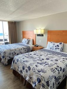 a hotel room with two beds and a window at Oceanview Inn - Emerald Isle in Emerald Isle
