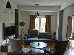 a living room with a couch and a table at Central Pearl Apartment in Ohrid