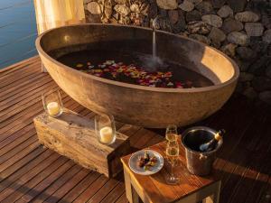 a large bath tub with candles on a wooden deck at The Vines Resort & Spa in Los Sauces