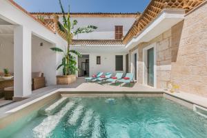a swimming pool in a villa with a house at YupiHome Holiday Home Can Cremat in Sa Pobla