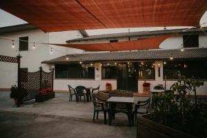 a patio with chairs and a table and a building at Hotel La Scottiglia e Ristorante in Seggiano