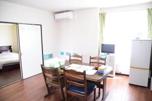 a dining room with a table and chairs and a bedroom at Ark City Asahikawa - Vacation STAY 8508 in Asahikawa