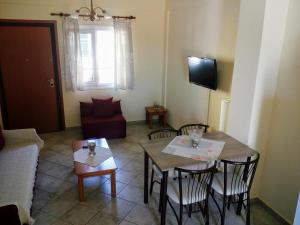 a living room with a couch and a table and chairs at Dasea Houses in Ormos Panagias