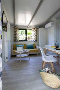 a living room with a couch and a table at Tamarit Beach Resort in Tamarit