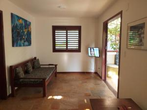 un soggiorno con un divano e una finestra di Paraiso Tropical - Casa 7 a Pipa
