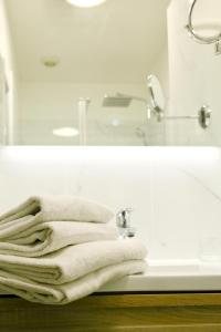 a bathroom with white towels sitting on a sink at Hotel Belle-Vue Vieux-Port in Marseille