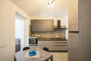 a kitchen with a table and a dining room at Tatta & Nanna Apartment in Oliena