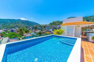 a swimming pool on the roof of a house with a view at Tres Marias Luxury Suites - Adults Only in Puerto Vallarta