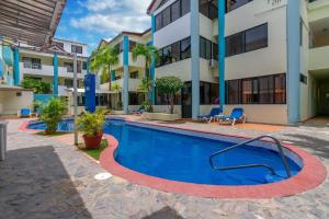 a swimming pool in front of a building at Hotel Plaza Europa in Sosúa