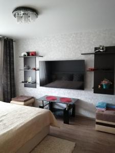a bedroom with a bed and a table and a bed at Apartment on Lenina 49 in Salihorsk