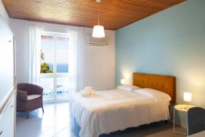 Postel nebo postele na pokoji v ubytování Paradise Relais Villa Janto'
