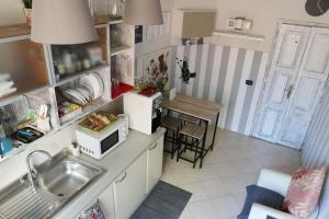 a small kitchen with a sink and a table at Guest House Relais Indipendenza in Rome