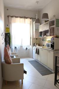 a kitchen with a couch and a table and a window at Guest House Relais Indipendenza in Rome