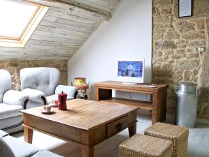 a living room with a wooden table and chairs at Apartamentos Teixoeira in Artes