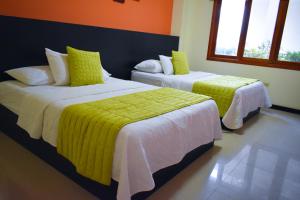 Postel nebo postele na pokoji v ubytování Hotel La Laguna Galapagos