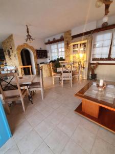 a large living room with a table and chairs at Elenis Studios in Arkasa