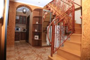 a room with a staircase and a kitchen at ANNAMARI in Pavshyno