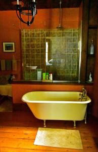 a bath tub in a bathroom with a mirror at Fisherman's Daughter B&B in Mahone Bay