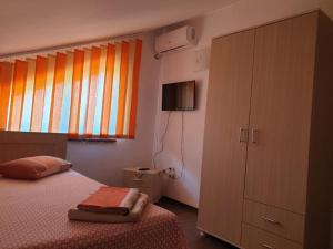 a bedroom with a bed and a dresser and a window at Casa di Madi in 2 Mai