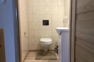 a small bathroom with a toilet and a sink at Domek Polny czar in Pogorzelica +18 photos