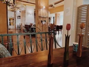 a room with a railing and a dining room at Hotel Shterev Sopot in Sopot