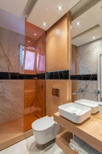 a bathroom with a toilet and a sink and a shower at Studios Filipidis in Chrysi Ammoudia